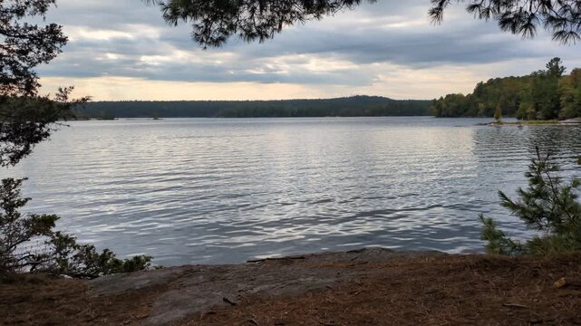 Sunrise on the Charleston Lake, with the Croziers Island in background, viewed from the Shoreline trail of the Charleston Lake Provincial Park (Lansdowne, Ontario, Canada)