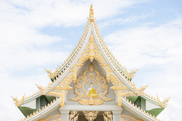 Naklejka premium thai temple gable with golden buddhist relief