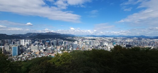 Modern Seoul, South Korea panoramic view.  Skyline. Mountains, forests and urban capital architecture. Sunny day. Top view
