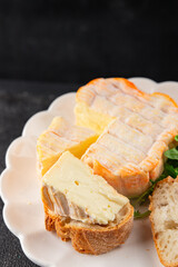 Washed rind cheese soft cheese with orange rind munster french cheese tasty snack fresh delicious gourmet food background on the table rustic top view copy space