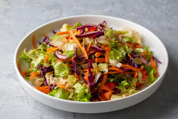 Turkish style lettuce salad. Diet salad with lettuce, red cabbage, tomatoes, and carrots.