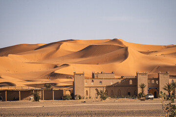 Building in front of the dunes of Merzouga desert, Morocco