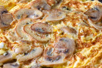 Frittata is an Italian type of omelet. Omelet with mushrooms cast-iron pan.
