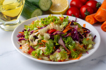 Turkish style lettuce salad. Diet salad with lettuce, red cabbage, tomatoes, and carrots.