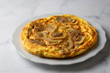 Frittata is an Italian type of omelet. Omelet with mushrooms cast-iron pan.