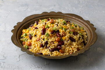 Bulgur pilaf with legumes; with peas, beans and corn kernels.