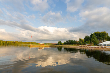 Fototapeta premium Calm lake with a dock and a few boats