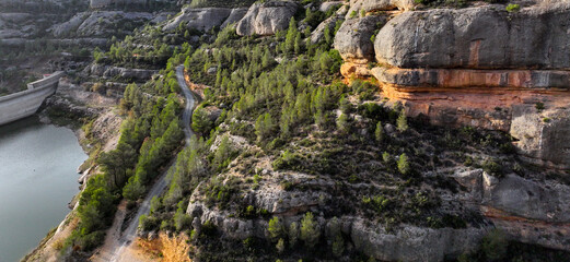 Aerial view of Margalef canyon at sunset with rocks and beautiful river.