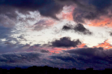 Urban landscape. Black clouds with red highlights over the city before a hurricane.