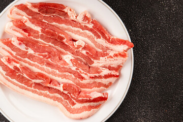 Bacon slice lard with meat slices pieces pork tenderloin portion size natural product tasty snack fresh delicious gourmet food background on the table rustic top view copy space