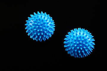 Bright blue spiky spheres on a black background showing an artistic representation of microscopic life forms