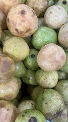 Fresh Ripe Guavas in Natural Market Display with Green and Yellow Skin