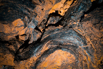 Lava formations, stones, black basalt in the rocks closeup on a volcano terrain.