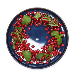 Christmas food. Pomegranate seeds, mint and rosemary isolated on white, top view