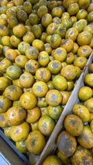Ripe Yellow Oranges in Wooden Crate on Market Stall