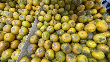 Yellow and Green Lemons in Wooden Bins at Market Fresh and Ripe