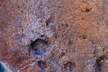 Terracotta stained oncrete wall with holes Texture Background