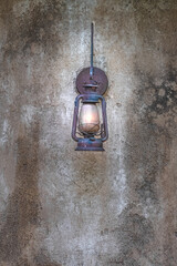 Antique Lantern on Weathered Concrete Wall
