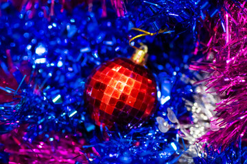 Colorful holiday decoration scene, Reflective glass ball amid metallic strands and glowing light effects