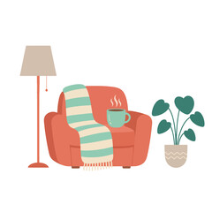 Cozy armchair setup for relaxation with warm blanket and drink