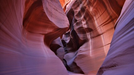 curved sandstone flow inside antelope canyon glowing with warm light, vibrant smooth carved canyon walls shaped by natural erosion, dramatic narrow rock passage with colorful sandstone