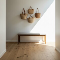 Minimalist home entryway with a wooden bench and hanging straw bags in natural sunlight.