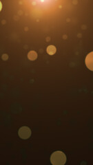Soft glowing golden bokeh lights floating on a dark background with a warm dreamy atmosphere