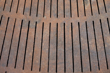 Industrial Decay: Close-Up of Perforated Sheet Metal with Corroded Surface and Striking Rust Textures