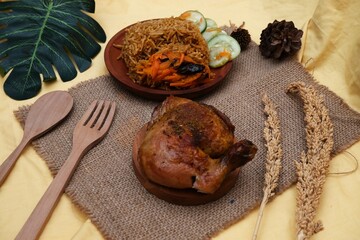 Traditional Middle Eastern-influenced Indonesian nasi kebuli served with roasted chicken, vegetables, and rustic decor for cultural dining presentation.