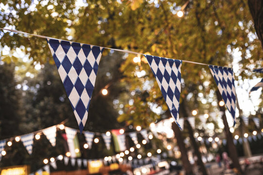 Oktoberfest bunting flags and string lights decorating outdoor festival