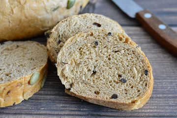 Freshly Baked Seeded Bread Slices on a Rustic Wooden Surface macro