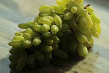 Green grapes or berry close display. Summer Fruit. Popular, crisp fruit known for their sweet, refreshing flavor and versatility.