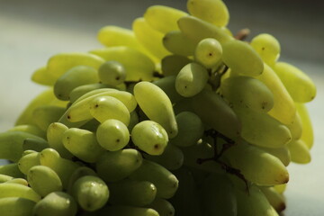 Green grapes or berry close display. Summer Fruit. Popular, crisp fruit known for their sweet, refreshing flavor and versatility.