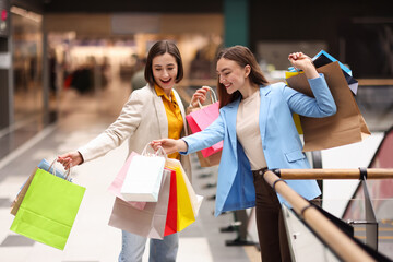 Women with different shopping bags in mall