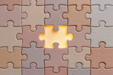 Obraz premium Puzzle piece missing from pastel jigsaw puzzle, glowing light, problem solving concept