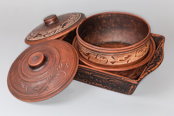 Different red clay baking crockery on a gray background