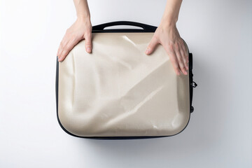 female hands closing a suitcase