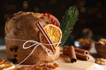 Christmas food. Delicious Panettone cake, ingredients and festive decor on table against background...