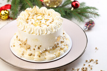 Delicious cake with Christmas decor on white table, closeup