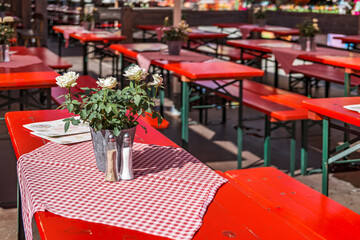wooden benches and tables at a typical bavarian beergarden