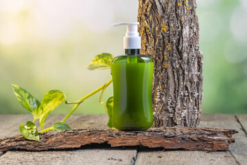 containers for skin care products on a wooden background surrounded by tree bark and green leaves