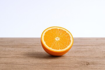 Naklejka premium Vibrant Orange Slice Displayed on Rustic Wooden Tabletop, Emphasizing Freshness and Natural Beauty