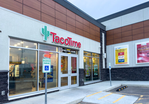 Calgary, Alberta, Canada. Oct 30, 2025. TacoTime fast food restaurant exterior storefront with cactus logo, entrance doors, and accessible parking in modern retail plaza