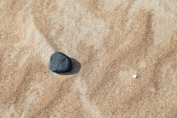 Beautiful dry, smooth pebbles on the beach of Baltic Sea. Sunny summer day in Latvia.