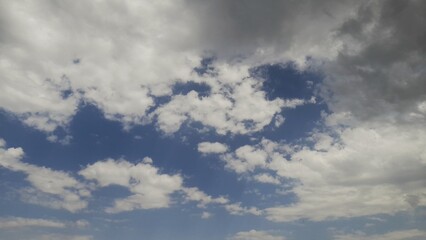 Dramatic contrast between sky void and patchy clouds.