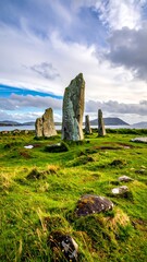 Ancient standing stones in a grassy field beneath a cloudy sky, distant islands visible