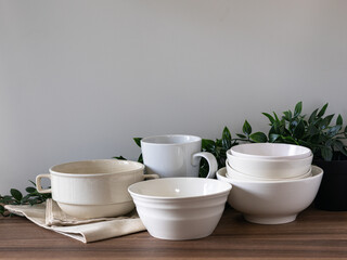 White Ceramic Tableware Bowl Set with Green Leaves on Wooden Table Minimal Kitchen