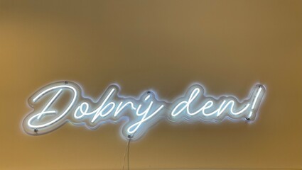 Neon sign that says Dobry Den in Czech