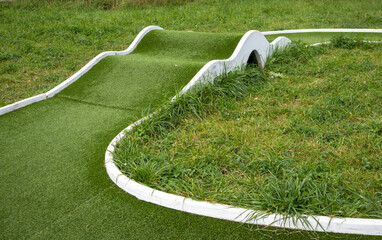 Mini golf lane with wavy hills and tunnel horizontal