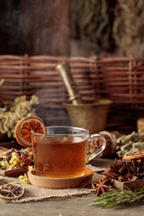 Tea with ingredients and slices of dried oranges.